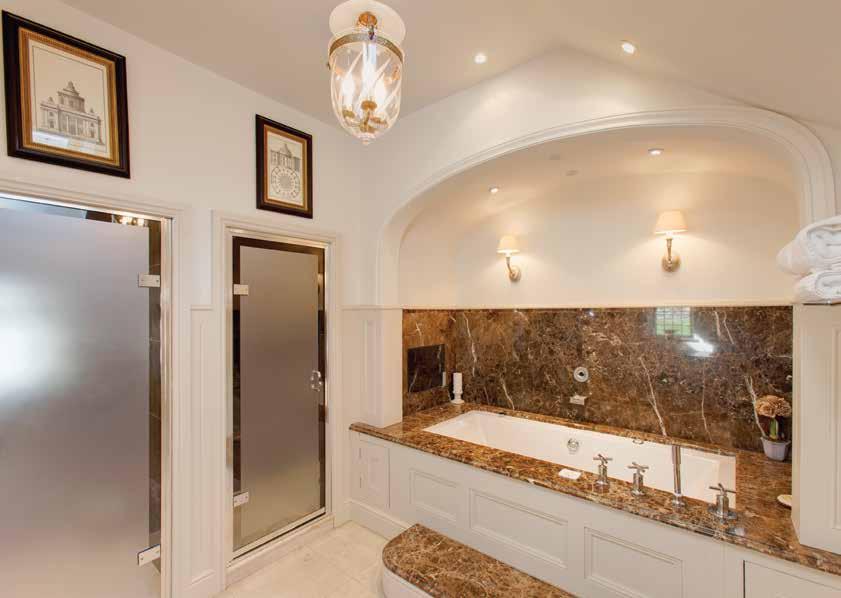 granite work surfaces, vanity mirrors over and fitted storage beneath.