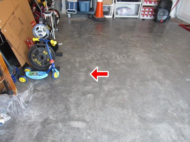 3.2 Minor cracks (approximately 1/8" - 3/16" in width) visible on the garage floor.