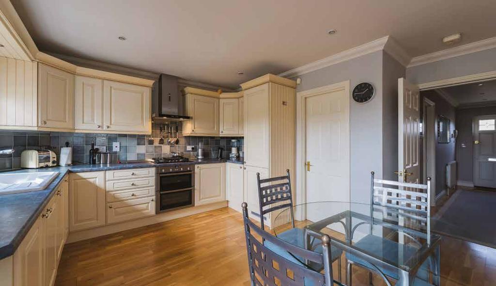 KITCHEN BREAKFAST ROOM 4.95m x 4.25m Window and half-glazed double doors to rear aspect. Fitted with a range of base and wall mounted units with complementary worksurfaces. Tiled splashbacks.
