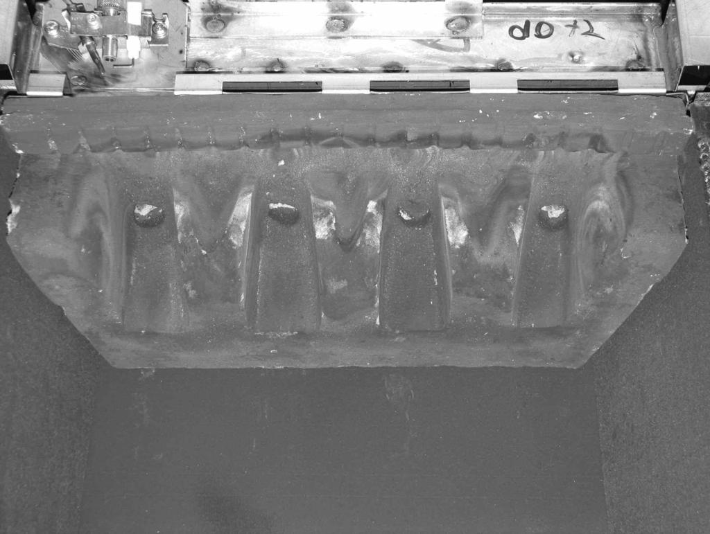 6.9.2 Position the front ceramic coal support onto the burner support as shown below in figure 16. Fig. 16 Positioning of front ceramic coal support onto burner support 6.9.3 Fit four of the specially shaped coals as shown below in figure 17.