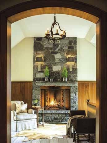 RIGHT: The master bath is one of the few rooms where curtains were used, softening the windows while imparting a sense of privacy. BELOW: A fireplace warms the master bedroom s sitting area.