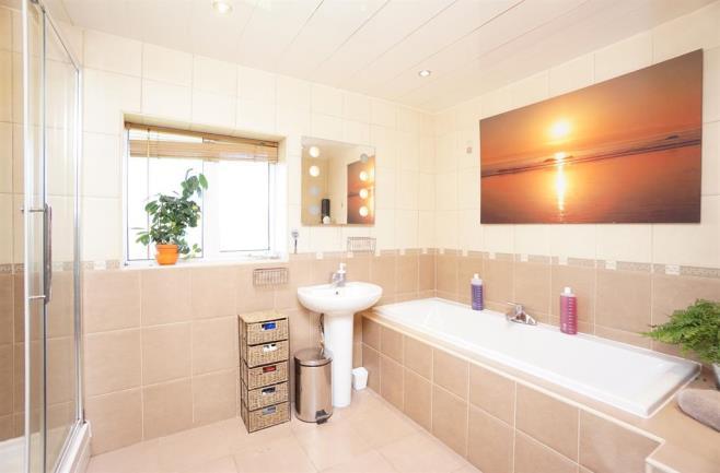 BATHROOM The luxury bathroom comprises a white suite of bath,