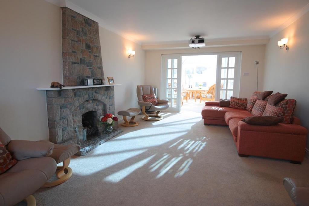 There are four double bedrooms all en suite, a sitting room with home cinema and a fabulous conservatory opening to the dining room kitchen and decked enclosed south east facing garden with swim spa