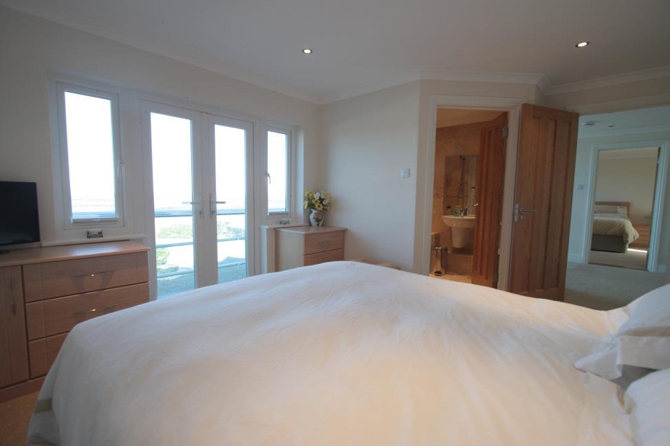 Bedroom 2 14 5 x 14. Double doors with windows to the side to the balcony excellent sea views. Two 2 drawer bedside cabinets and 2 further 3 drawer chests.