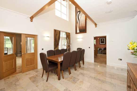 Built-in oak display cabinet and storage cupboards. Double opening doors from reception hall and dining hall.