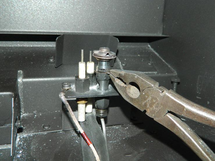 From inside the fi rebox, remove pilot retainer clip with pliers and pull off the pilot cap to expose the pilot