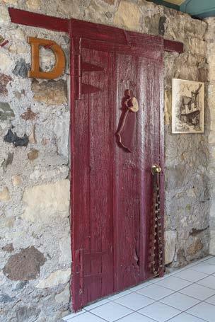 RIGHT: Originally used as accommodation for the farm labourers, the wide farm door holds the key to the home s