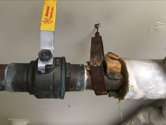 signs of water damage from condensate occurring on the exterior surface of the piping and possible small pipe leaks which may have occurred