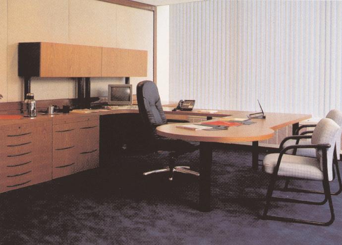 A combination of light ash wood and contrasting laminate worksurfaces results in a distinctive private office.