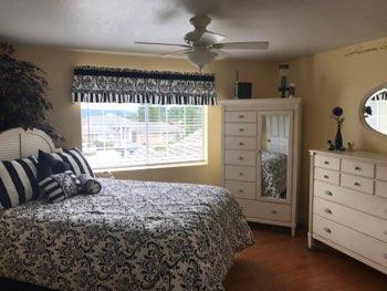 1. Bedroom Master Bedroom Walls and ceilings appear in good condition overall. Flooring is wood in good condition overall. Heat register present.