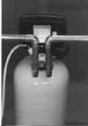 CAUTION: IF COPPER PIPING WITH SWEAT FITTINGS IS USED, DO NOT SWEAT DIRECTLY INTO THE IN/OUT MANIFOLD OF SOFTENER VALVE OR BY-PASS VALVE. HEAT WILL DAMAGE PLASTIC PARTS.