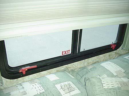 SECTION 2 SAFETY AND PRECAUTIONS SLIDEOUT ROOMS WARNING Escape Window - Lift latch handles upward to open Using Slider Windows As Emergency Exits Some coaches are required to have a slider window as