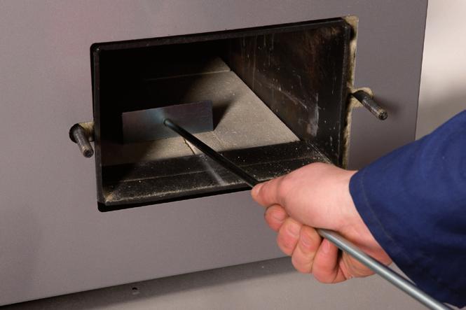 Open the cleaning hatch at the side and remove any loose incrustation with an ash scraper. 4. Open the firebox hatch, clean the grate and empty the ashbox into a fire-proof ash bucket. N.B.