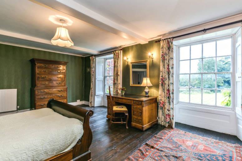 There is fine carved oak linenfold panelling with wide oak floorboards which have been created in the family/billiard room which leads onto the garden room with French windows leading onto the