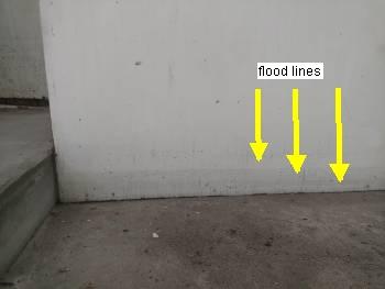 Water marks on the walls in the lower level indicate past flooding issues during heavy rain events. 3.