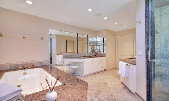 The wainscoting is polished sandstone, as is the floor and the frame of the deep jetted tub.