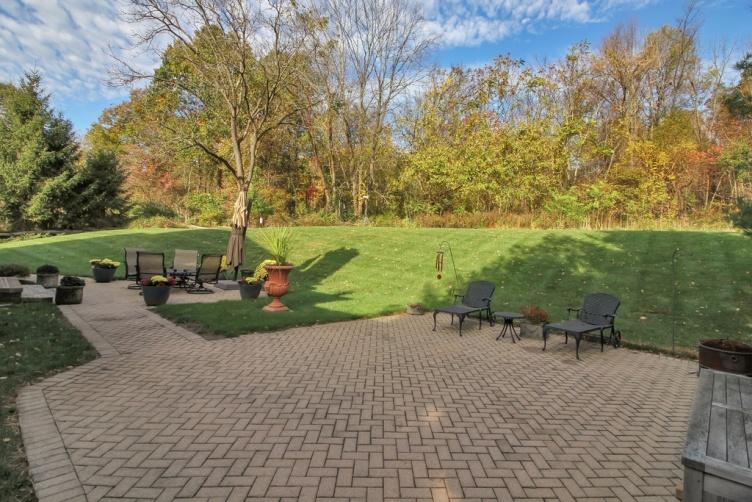 A custom paver patio is designed to provide an outdoor dining area and the