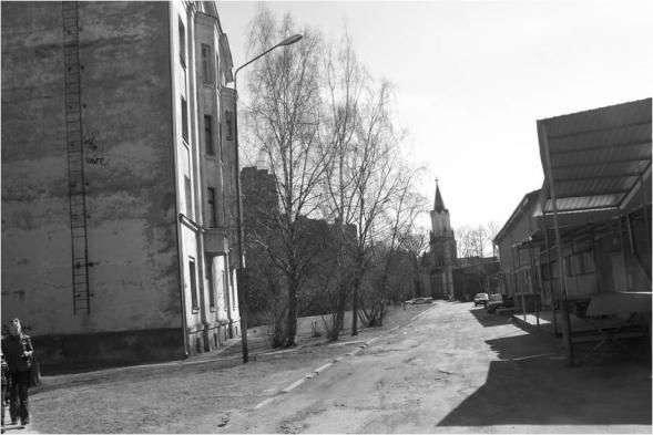Fig. 4. Jelgava. Old Katolu street zone with dwelling house and S. Jana church (2012) [Source: photo by the author] Fig. 5. Jelgava. The new street in cemetery territory S.