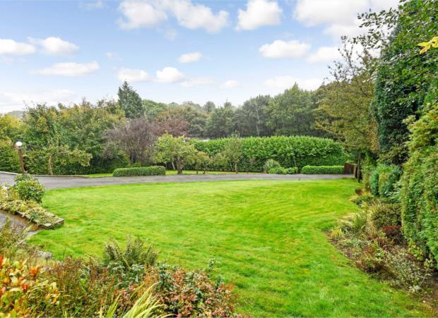 GARDENS The property stands central to its plot which extends to around an acre To the front and to either side of the driveway there are lawns bordered by mature trees
