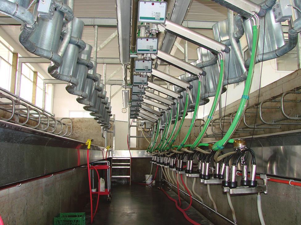 Figure 2. Crowd gates help move cows into the parlour. Figure 3. Rotating arms keep hoses out of the way.