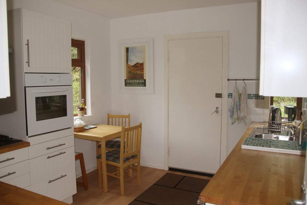Step and door into hallway, with access to living room, kitchen and bathroom and stair to upper floor. Two cupboards.