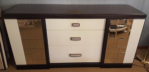 Bevelled mirrors on the doors. 3 central drawers in the center covered with leather.