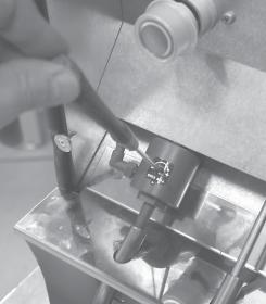 Pushing the centre of the pinch solenoid valve and sliding the tube in from the side, fixes the