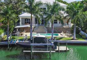 backyard Palm trees Outdoor pool Outdoor kitchen Dock with 2 boat lifts In-ground pest control