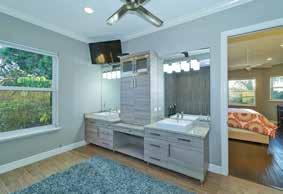 cabinet between vanities Americh jetted bathtub with tile surround and tile