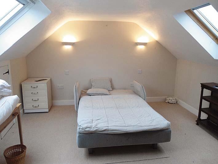 2m (6 8 X 13 10 at widest) Cosy room with velux window; combed ceiling; overhead and wall light; pedestal wash hand basin with tiled splash back; mirrored cabinet; television point; power points;