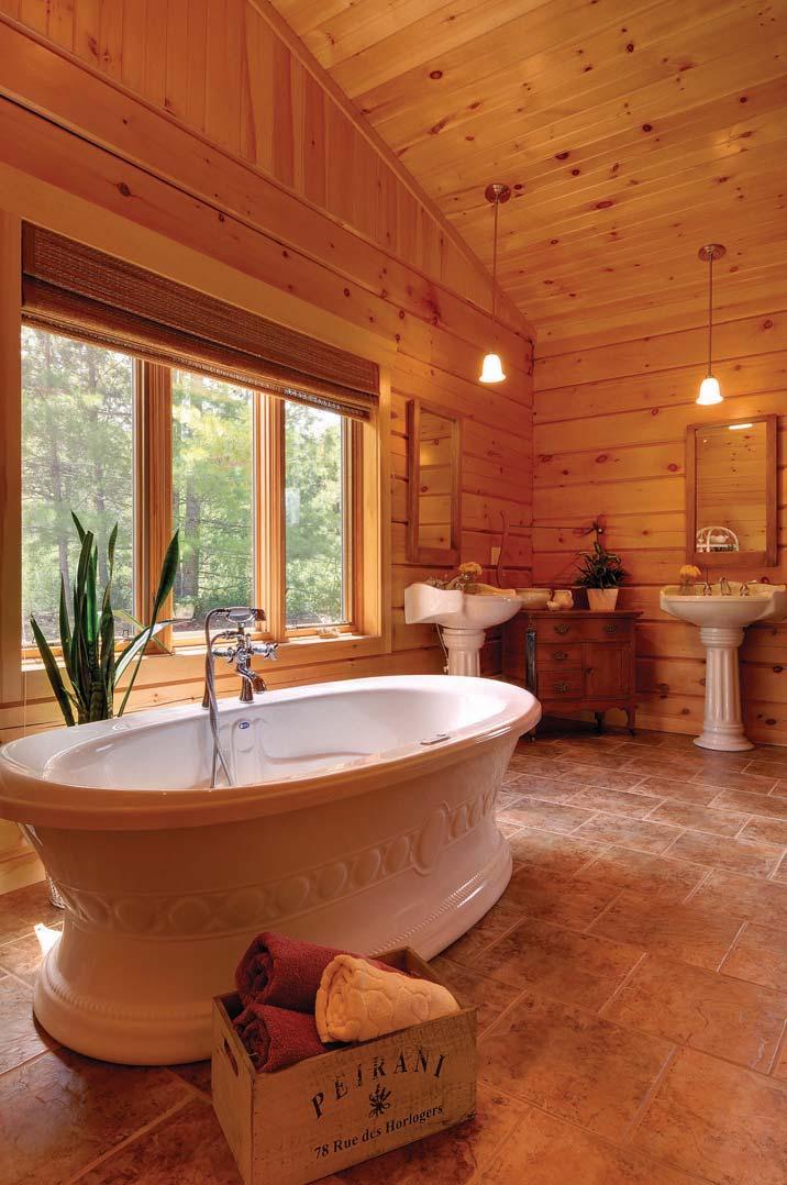 The large master bath lets in lots of natural light and has plenty of charm with a relaxing vessel tub, his-and-her pedestal sinks and glassed-in shower.