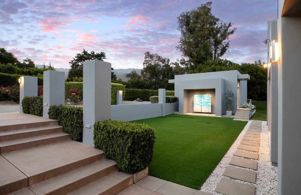 The geometrical composition of the home s façade offers bold and striking design elements with unique sculptures and landscape details.