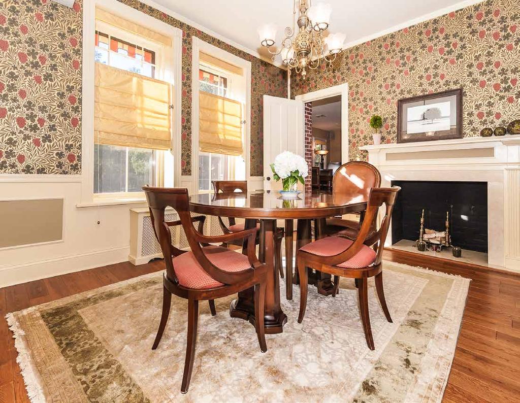 Dining Room with new wide-plank hardwood floor, period wallpaper, chair-rail and picture moldings, gas fireplace with marble surround and