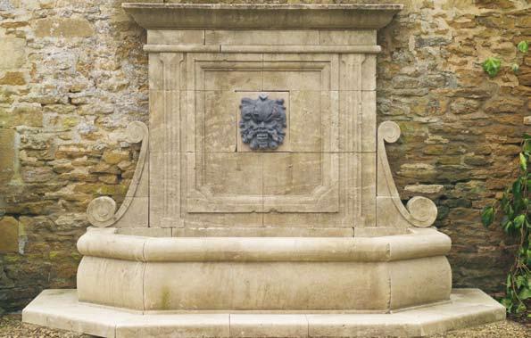 The Neptune Wall Fountain with Grotesque Mask [item 9] A large hand carved natural limestone wall fountain having an elegant carved wall plate