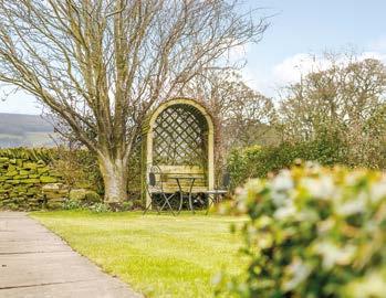 Approached via a private drive flanked by natural dry-stone walls and level lawn gardens which have well