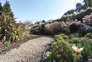 ornamental pond, sweeping lawns, aluminium greenhouse and vegetable area,