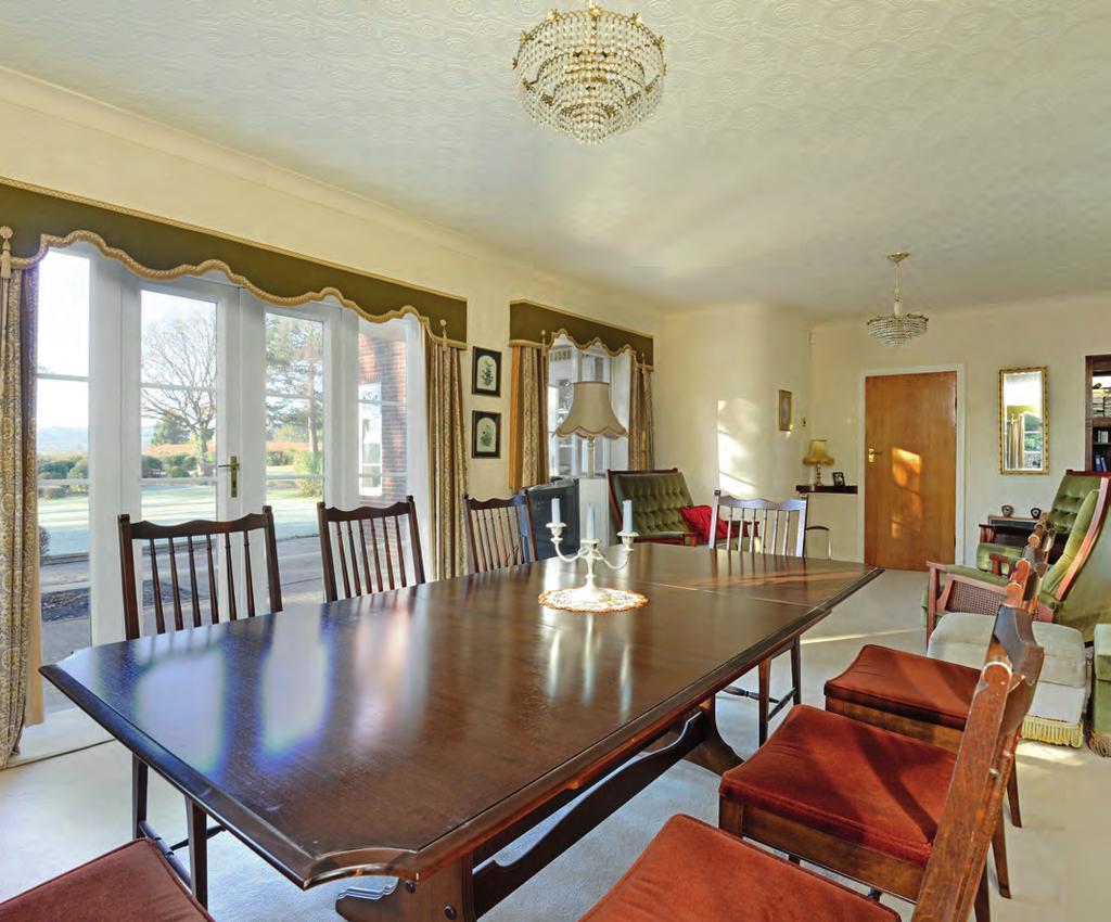 A spacious dining room has windows to three elevations taking full advantage of the long distance countryside views.