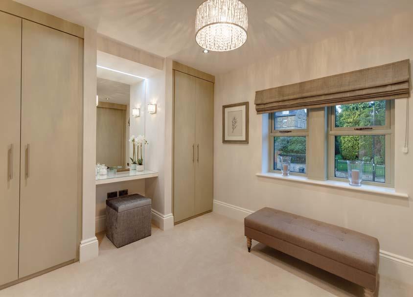 a large inset mirror to one wall with feature recessed lighting above and a shaver point.