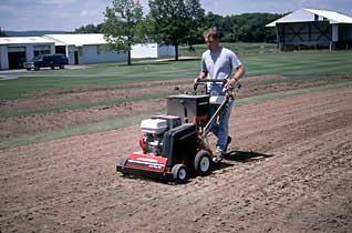 Then rake up the thatch and remove it from the site. Figure 19. Aerating a site with a core aerator Following thatch removal, apply amendments recommended on the soil test report.