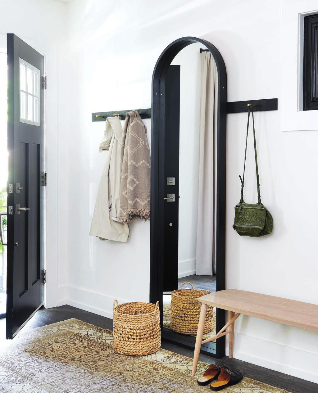 + + + + + + + + + + + + + + + + The entryway boasts a simple and striking mix of functional furnishings.