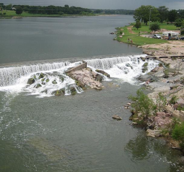 The spilling water effect may bear some resemblance to this Llano River example. which causes it to drain poorly during wet periods or after floods.