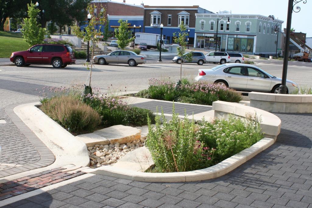 West Union and other projects have incorporated permeable paving into the streets, sidewalks, and parking lots; bioretention into sidewalk planters and protected parking bumpouts; and green roofs