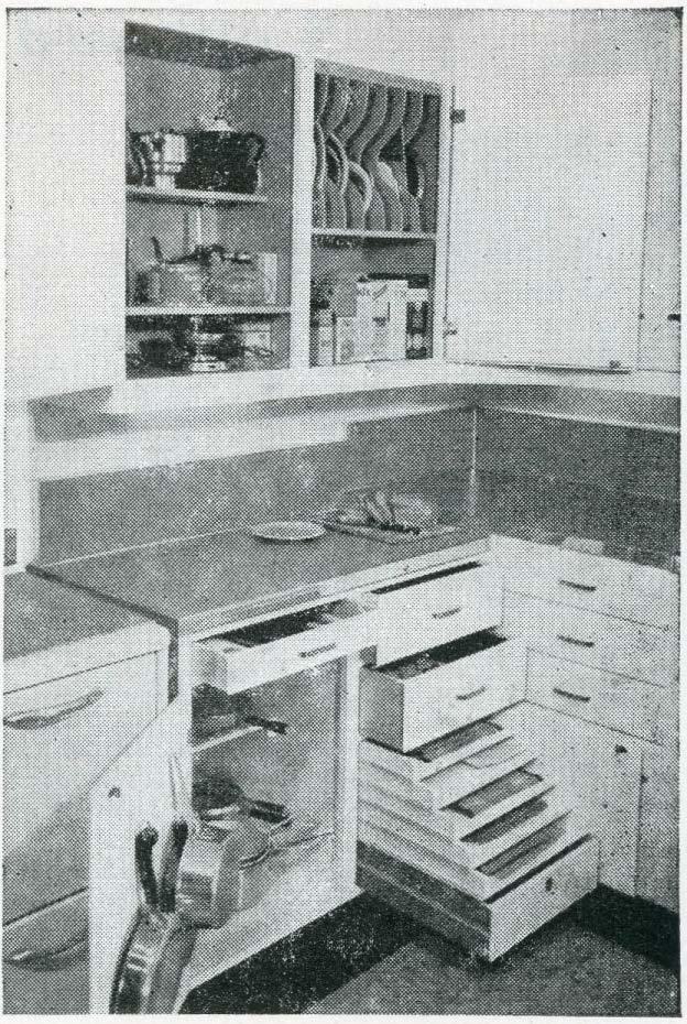 The lower left part of the cupboard is a shallow drawer for forks, spoons, holders and equipment which you would use at the stove.