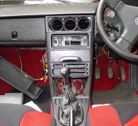 In the above picture, the air vents have been removed (easy, put your fingers in the vents and pull gently or use a blade to lever the rectangular mounting plate off) and so has the radio.