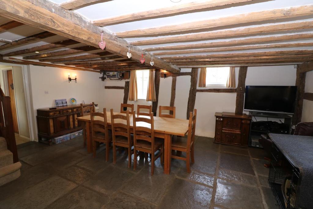 Dining Room/Day Room Timber door with thumb latch into Utility Room measuring approximately 7 x 8 (2.13 x 2.44m) maximum with enclosed oil central heating boiler (Worcester), ample slatted shelving.
