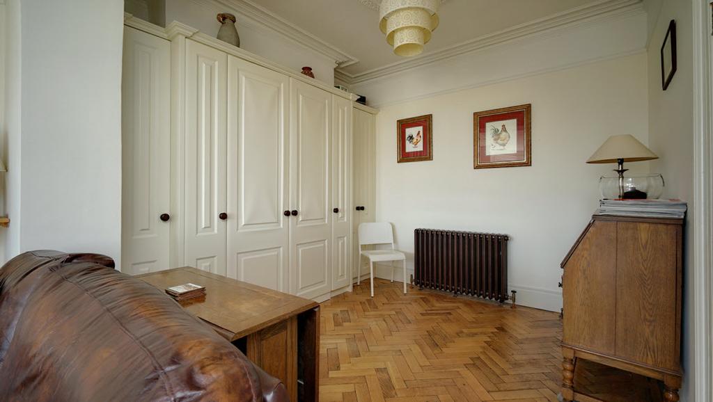 Open plan to... STUDY: 10' 3" x 9' 2" (3.12m x 2.79m) Bespoke cabinets incorporating home office desk etc, Parquet flooring.