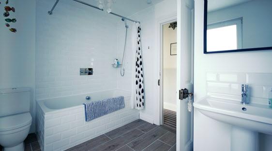 62m) BATHROOM: White bathroom suite comprising tiled bath, mixer tap, thermostatic