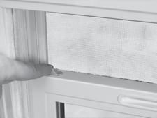 . Unlock and slightly raise the lower sash (). Release the tilt latches located on the top of the lower sash, and pull the sash toward the interior of the room (2).