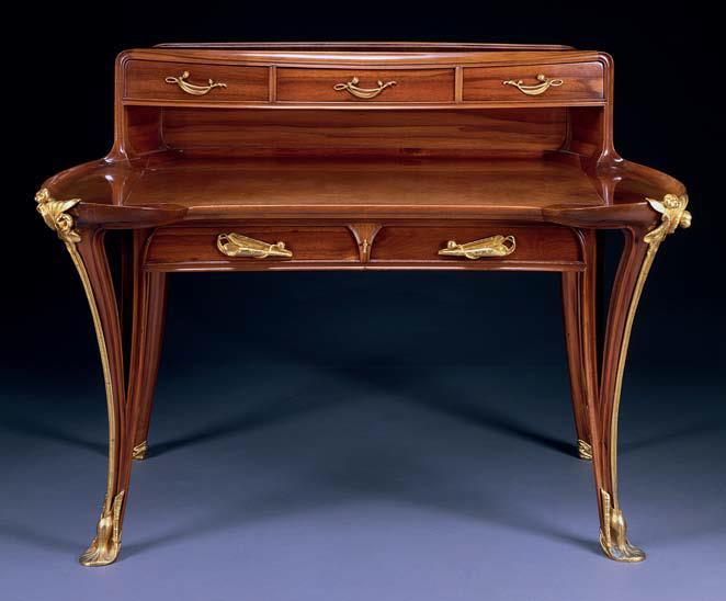 This desk has the characteristic flowing lines following Hogarth s Line of Beauty, and the curvilinear, nature-inspired ornamentation of the turn of the century.
