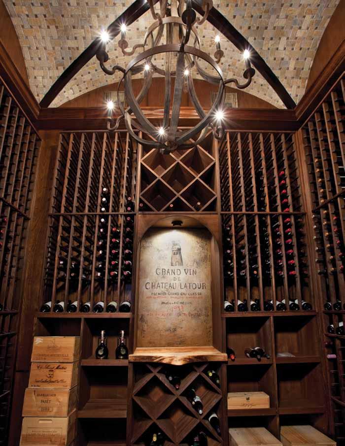 The wine room, conveniently situated off the bar, holds the homeowners vast collection from around the world. A commissioned artist recreated a favorite wine label behind the serving area.
